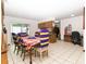 Open dining area with a classic table setting, seamlessly connected to the kitchen and outdoor patio at 731 Cloverleaf Blvd, Deltona, FL 32725