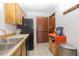 The kitchen features black appliances, wooden cabinets, and a tile floor at 731 Cloverleaf Blvd, Deltona, FL 32725