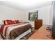 Bright main bedroom with a large bed and a window overlooking a private yard at 731 Cloverleaf Blvd, Deltona, FL 32725