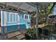 View of the shed from the side with decorative plants, rocks and an awning at 731 Cloverleaf Blvd, Deltona, FL 32725