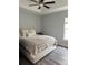Bedroom with wood floors, a ceiling fan, and a side window at 7407 Sw 202 Ct, Dunnellon, FL 34431
