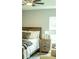 Comfortable bedroom with wood floors, a ceiling fan, and a large window at 7407 Sw 202 Ct, Dunnellon, FL 34431