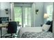 Bedroom featuring a desk and sliding glass door to screened in patio at 7407 Sw 202 Ct, Dunnellon, FL 34431