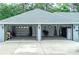 Spacious three-car garage offering ample parking and storage space with modern doors and lighting at 7407 Sw 202 Ct, Dunnellon, FL 34431