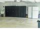 Functional garage space including storage cabinets, utility sink, and extra refrigerator-freezer unit at 7407 Sw 202 Ct, Dunnellon, FL 34431