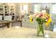 Close-up of kitchen counter, showing granite countertops and natural flowers at 7407 Sw 202 Ct, Dunnellon, FL 34431