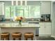 Bright kitchen featuring an island with seating, granite countertops, and stainless steel appliances at 7407 Sw 202 Ct, Dunnellon, FL 34431