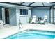 Screened in pool area with tiled pool, outdoor furniture and a view to the house at 7407 Sw 202 Ct, Dunnellon, FL 34431