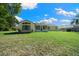 Well-maintained backyard featuring lush green grass and a view of the home's rear exterior at 7692 Sw 117Th Street Rd, Ocala, FL 34476