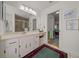 Well-lit bathroom with a large vanity, spacious mirror, and walk-in shower, enhanced by a clean and modern aesthetic at 7692 Sw 117Th Street Rd, Ocala, FL 34476