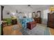 Inviting bedroom with wood floor, a ceiling fan, complemented by a traditional furniture set and soft, natural light at 7692 Sw 117Th Street Rd, Ocala, FL 34476