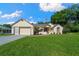 Charming single-story house with an attached garage and lovely green lawn at 7692 Sw 117Th Street Rd, Ocala, FL 34476