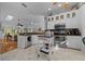 Bright kitchen boasting white cabinets, granite countertops, stainless steel appliances, and an island for added convenience at 7692 Sw 117Th Street Rd, Ocala, FL 34476