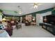 Spacious living room with multiple seating areas, bright windows, and comfortable furnishings at 7692 Sw 117Th Street Rd, Ocala, FL 34476