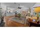 Inviting living room with hardwood floors, skylight, and open layout to kitchen and dining areas at 7692 Sw 117Th Street Rd, Ocala, FL 34476
