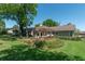 Spacious backyard with a wooden deck, pergola, and lush landscaping perfect for entertaining at 8120 Nw 48Th Ln, Ocala, FL 34482