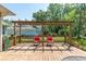 Cozy backyard deck with a pergola and seating, perfect for outdoor enjoyment at 8120 Nw 48Th Ln, Ocala, FL 34482