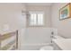 Bathroom offers a bathtub with white tile walls and a heated towel rack at 8120 Nw 48Th Ln, Ocala, FL 34482