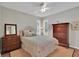 Cozy bedroom featuring a comfortable bed, elegant dressers, and ample natural light at 8120 Nw 48Th Ln, Ocala, FL 34482
