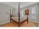 Traditional bedroom with a canopy bed, neutral decor, and plenty of natural light at 8120 Nw 48Th Ln, Ocala, FL 34482