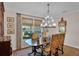 Chic dining area with a large window, sophisticated lighting, and ample seating at 8120 Nw 48Th Ln, Ocala, FL 34482