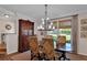Bright dining area with large window, stylish lighting, and beautiful wood accents at 8120 Nw 48Th Ln, Ocala, FL 34482