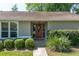 Charming entryway with a red front door framed by sidelights and manicured greenery at 8120 Nw 48Th Ln, Ocala, FL 34482