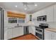 Bright kitchen with white cabinetry, stainless steel appliances, and plenty of counter space for cooking at 8120 Nw 48Th Ln, Ocala, FL 34482