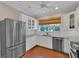 Well-lit kitchen with stainless steel refrigerator, granite countertops and ample storage space at 8120 Nw 48Th Ln, Ocala, FL 34482