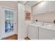 Convenient laundry room with white cabinets and modern washer and dryer at 8120 Nw 48Th Ln, Ocala, FL 34482