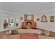 Cozy living room features a stone fireplace and access to the outdoors at 8120 Nw 48Th Ln, Ocala, FL 34482