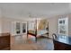 Spacious main bedroom with four poster bed, and sliding glass doors to lanai at 8120 Nw 48Th Ln, Ocala, FL 34482