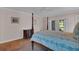 Bedroom features a comfortable bed, dresser, and french doors to the outside area at 8120 Nw 48Th Ln, Ocala, FL 34482