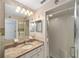 Bright bathroom with granite countertops, modern fixtures, and a glass-enclosed shower at 8371 Sw 109Th St, Ocala, FL 34481