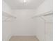Walk-in closet with white walls and open shelving on either side of the room at 8371 Sw 109Th St, Ocala, FL 34481