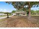 Inviting home exterior with mature trees, manicured lawn, and sidewalk at 8371 Sw 109Th St, Ocala, FL 34481