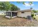 The exterior of the house with a sunroom provides a comfortable living space for enjoying the outdoors at 8371 Sw 109Th St, Ocala, FL 34481