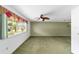 Spacious living room with large window and ceiling fan for natural light and comfort at 8371 Sw 109Th St, Ocala, FL 34481