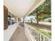 Covered front porch with a view of a large tree at 8371 Sw 109Th St, Ocala, FL 34481