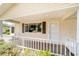 Inviting front porch with white railing, offering a view of the neighborhood at 8371 Sw 109Th St, Ocala, FL 34481