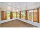 Bright sunroom featuring tile floors, large windows and light filtering curtains that offer plenty of natural light at 8371 Sw 109Th St, Ocala, FL 34481