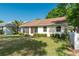 A well-maintained backyard featuring green grass, trimmed bushes, and a white privacy fence at 9101 Sw 91St Cir, Ocala, FL 34481