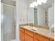 Bathroom with a glass shower, granite countertop, and wooden vanity at 9101 Sw 91St Cir, Ocala, FL 34481