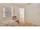 Bright bedroom with neutral paint, wood floors, and natural light from window at 9101 Sw 91St Cir, Ocala, FL 34481