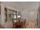 Bright breakfast nook featuring natural light and a wooden table set for four at 9101 Sw 91St Cir, Ocala, FL 34481