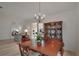 Dining area includes wood floors, chandelier, and large china cabinet display adding a touch of elegance at 9101 Sw 91St Cir, Ocala, FL 34481