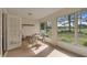 Florida room with large windows offering stunning views of the well-maintained lawn, creating a serene retreat at 9101 Sw 91St Cir, Ocala, FL 34481