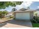 Attached garage with a brick facade and a white garage door on a concrete driveway at 9101 Sw 91St Cir, Ocala, FL 34481