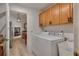 Convenient laundry room with upper cabinets and a utility sink at 9101 Sw 91St Cir, Ocala, FL 34481