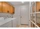 Functional laundry room with washer, dryer, and built-in cabinets at 9101 Sw 91St Cir, Ocala, FL 34481
